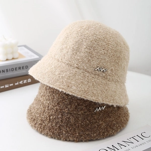 Winter bouclé bucket hats in beige and brown with metal W accent and soft fuzzy texture