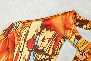 Detail of cutout neckline and artistic abstract print on a slim fit long sleeve dress
