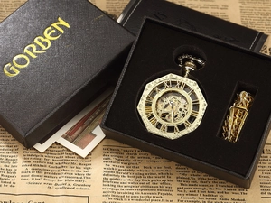 Detail of vintage octagonal hollow mechanical pocket watch in a black gift box