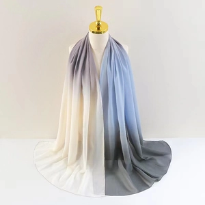 Detail of soft chiffon scarf with gradient color transition from white to blue
