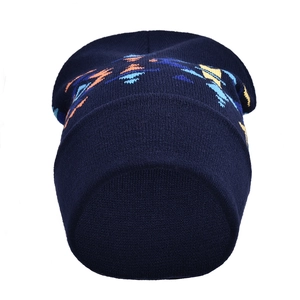 Detailed knit texture of navy blue beanie with colorful geometric patterns and cuffed hem