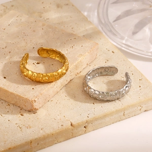 Minimalist adjustable flower pattern rings in gold and silver finish on a stone base