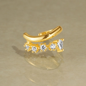 Macro shot of double-layer gold ear cuff with marquise and round clear zircon stones