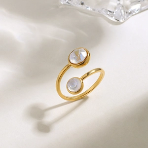 Detailed view of an 18K gold plated ring featuring two sparkling faceted round zircon stones