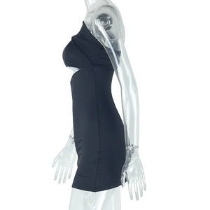 Detail of sexy one-shoulder black mini dress with waist cutout and matte elastic fabric