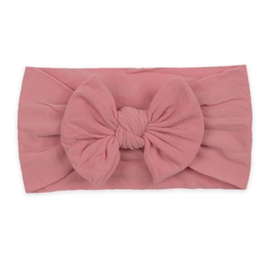 Soft nylon elastic headband for babies featuring a large pink bow decoration