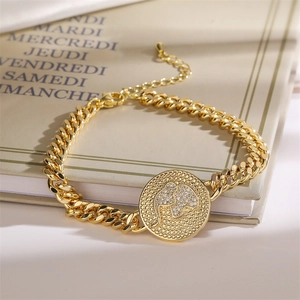 Detailed close-up of a golden Cuban chain bracelet featuring a micro-pave elephant charm