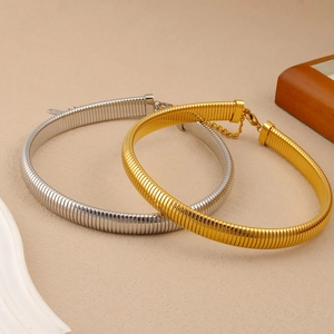 Detail of gold and silver snake bone choker necklaces with lobster clasp and extension chain