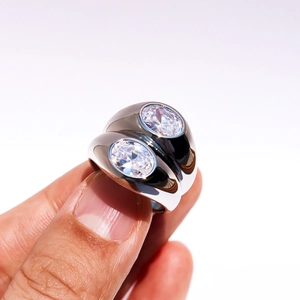 Double-layered wide silver ring with two oval cubic zirconia stones on white background