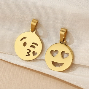 Detailed view of 18K gold plated heart and winking emoji charms on soft silk fabric