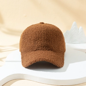 Close-up of brown sherpa teddy fleece texture on a warm winter baseball cap