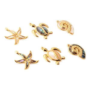 Detailed set of golden marine charms including starfish, turtle and shell with abalone shell inlay