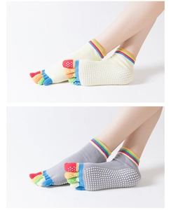 Detail of colorful five-toe yoga socks with non-slip silicone grips on the bottom