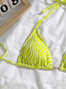 Detail of zebra print bikini top with pearl accents and textured fabric surface