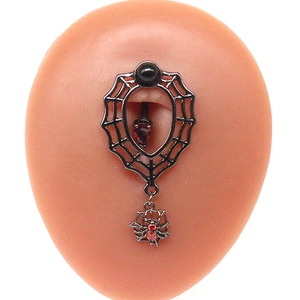 Detailed shot of gunblack spider web belly ring with black and red crystals on skin model