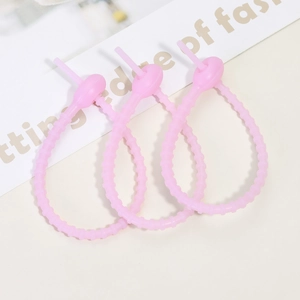 Three pink silicone cable ties with non-slip texture for securing cords and accessories