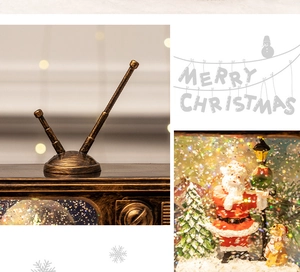 Detail of vintage bronze TV music box with Santa miniature and falling glitter inside