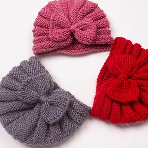 Cute knitted baby turban hats with large bows in pink, grey, and red for infants