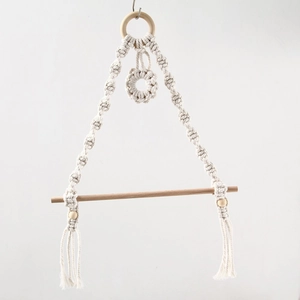 Detail of bohemian woven cotton rope tissue holder with natural wood beads and tassels