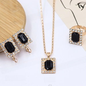 Detail view of bridal jewelry set with rectangular black gemstones and pavé crystals