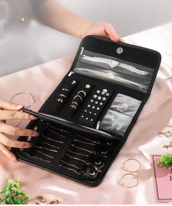 Detailed view of the multi-page black leather jewelry organizer with various compartments