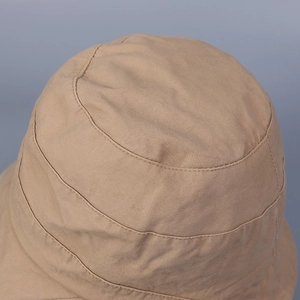 Minimalist khaki cotton bucket hat with breathable fabric and circular stitching details