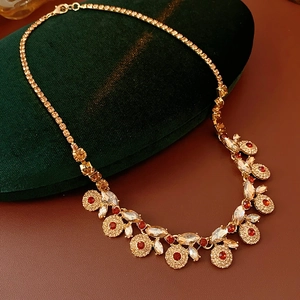 Macro shot of vintage style necklace with amber and red crystals on green velvet