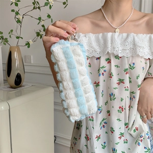Detail of blue and white bubble pleated fabric texture on soft stationery storage pouch