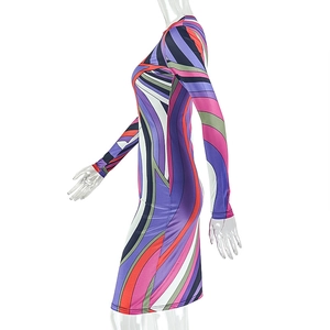Detail of the bodycon fit and colorful geometric swirl pattern on the long sleeve dress