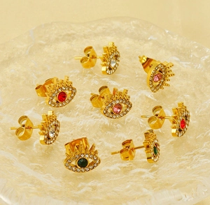 Detailed view of evil eye stud earrings with colorful crystals and gold plating