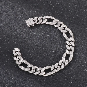 Close-up of iced out Cuban link chain bracelet with square clasp and rhinestones