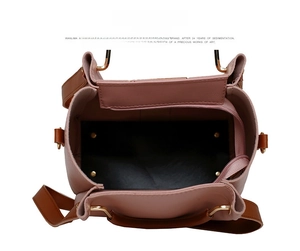 Detail view of pink leather bag interior featuring a secure zipper pocket and gold hardware