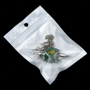 Cho Ku Rei faceted green crystal pendulum with gold power symbol on black background
