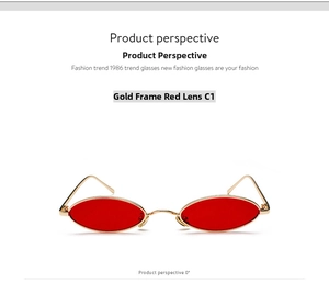 Detailed macro view of vintage gold metal oval sunglasses with translucent red lenses