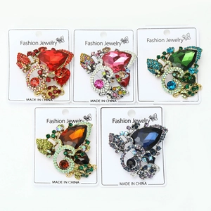 Detailed view of alloy flower brooches with water drop crystals and rhinestones in five colors