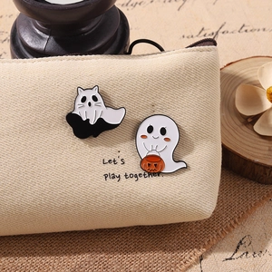 Ghost and cat enamel pins on a beige canvas bag with 'Let's Play Together' text