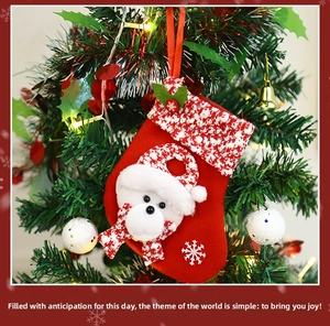 Detail of Christmas stocking featuring a 3D white teddy bear on a festive tree branch