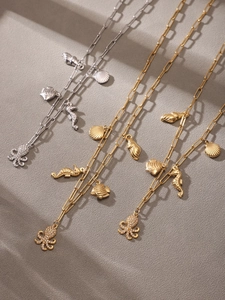 Detailed view of ocean-themed layered necklaces with octopus and shell charms