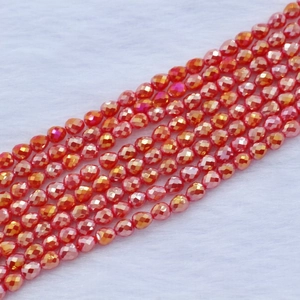 Macro detail of faceted orange teardrop beads with pearlescent finish for DIY jewelry