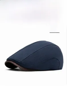 Detail view of navy blue woven cotton linen flat cap with brown leather brim accents