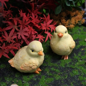 Miniature resin chicken figurines with detailed feather texture in garden landscape