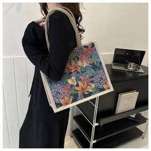 Detail of vintage floral jacquard fabric and cotton rope handles on a tote bag