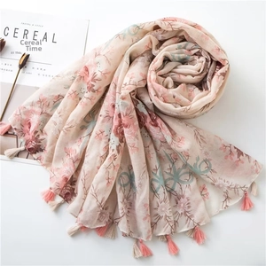 Detail of floral pomegranate print scarf with pink tassels on a soft cotton linen fabric