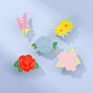 Detailed flat lay of five assorted floral enamel pins including rose and lavender