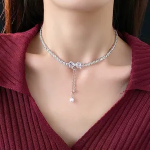 Elegant zircon bow pearl tassel necklace with silver rhinestone choker on woman