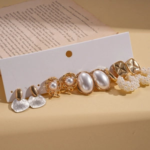 Ten-piece vintage pearl earrings set featuring floral and shell patterns on card