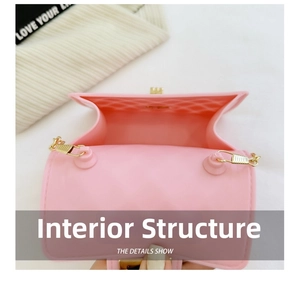 Detail view of pink jelly PVC bag interior with single compartment and gold lock