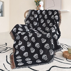 Bohemian black and white skull patterned knitted throw blanket with colorful fringe tassels