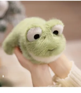 Close-up of soft green plush frog toy being held to show high-elastic fluffy texture