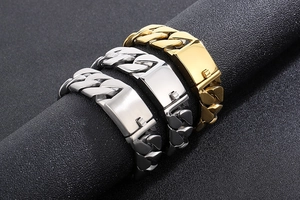 Macro view of 20mm Cuban link chain bracelets in gold and silver stainless steel